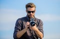 Flawless Moment. macho man with camera. photographer in glasses. travel with camera. male fashion style. looking trendy Royalty Free Stock Photo