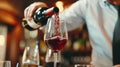 With flawless precision, a waiter& x27;s hand releases a scarlet waterfall of red wine, embodying the passion and allure