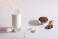 flax seed milk in glass on white background with plant. copy space. Royalty Free Stock Photo