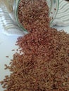 Flax seeds in the glass jar on white background, vintage color tone