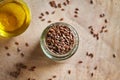 Flax seeds in a jar, with a bowl of flax seed oil in the background Royalty Free Stock Photo