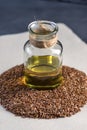 Flax seeds and linseed golden oil in a glass bottle on the table. Healthy diet with omega 3 fatty acids.