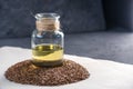 Flax seeds and linseed golden oil in a glass bottle on the table. Healthy diet with omega 3 fatty acids.