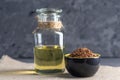 Flax seeds in a pile and linseed golden oil in a glass bottle on