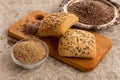 Flax seeds in silver bowl and Bread with flax seeds and milled seeds on the table