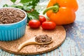 Flax seeds in a spoon and a bowl, fresh vegetables Royalty Free Stock Photo