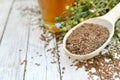 Flax seeds in spoon with linseed oil and linum plants