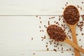 Flax seeds on wooden spoon on white background Royalty Free Stock Photo