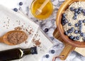 Flaxseed oil in a bottle near the seeds in a spoon. and honey and oatmeal with blueberries on wooden bowl. Healthy food Royalty Free Stock Photo