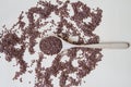 Flaxseeds on wooden spoon on beige background Top view.