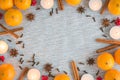 Christmas flat lay frame of oranges, candles, and spices