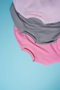 Flay lay of pale pink pastel and gray sport blank sweatshirts isolated on light blue background Royalty Free Stock Photo