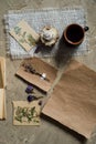 Flay lay, top view of the herbarium, dried lavender flowers, notebook, book for notes, pen and spring summer pictures on a concret Royalty Free Stock Photo