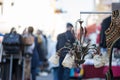 Flea market: Old fashioned lamp in the foreground, people in the blurry background