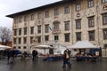 Flea market and Palazzo della Carovana at the Knights Square in Royalty Free Stock Photo