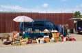 Flea market stand with car and lots of old things to sale Royalty Free Stock Photo