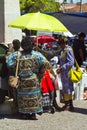 Lisbon, Portugal - May 4, 2013 Two darkskinned women in traditional vibrant colorful african clothes bying something in