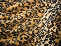 Fleecy brown draped leopard skin fabric Royalty Free Stock Photo