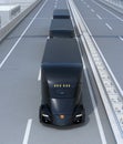 A fleet of black self-driving electric semi trucks driving on highway