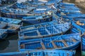 A fleet of blue wooden fishing boats docked in the port of Essaouira in Morocco. Royalty Free Stock Photo