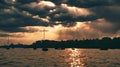 Fleet of boats in the tranquil water illuminated by the soft light of dusk by a cloudy sky