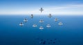 Fleet of Jet Aircraft Flying in Formation Over Calm Blue Ocean Royalty Free Stock Photo