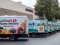 Fleet of Safeway home grocery delivery trucks outside of store location