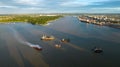 several ships float along the water near a city and bridge Royalty Free Stock Photo