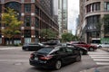 Fleet of vehicles drive down a bustling city street, with the Zara and Omni logos visible