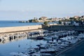 Fleet of vessels moored in the harbor by an ancient city wall: Marittimo, Cosenza, Italy