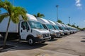 Fleet of White Commercial Vehicles in a Vibrant Industrial Setting