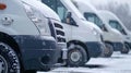 Fleet of white delivery vans in snowy day, copy space, transport service company concept Royalty Free Stock Photo