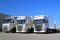 Fleet of White Scania and Volvo Trucks on a Yard