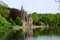 Flemish style castle reflecting in Minnewater lake in Bruges Royalty Free Stock Photo