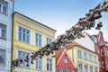 Flensburg, Germany, July 25, 2022:  Old shoes hanging on a rope between the houses across the shopping street Norderstrasse, Royalty Free Stock Photo