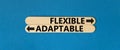 Flexible or adaptable symbol. Concept word Flexible Adaptable on beautiful wooden stick. Beautiful blue table blue background.