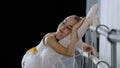 Flexible ballerina girl child in ballet tutu stretches near barre in dance class stretching legs with pleasure easy Royalty Free Stock Photo