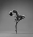 Flexible ballerina in pointe bends back Royalty Free Stock Photo