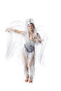 Beautiful young woman in carnival, stylish masquerade costume with feathers dancing on white studio background. Concept Royalty Free Stock Photo