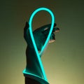 Flexible blue led tape neon in hand on black background Royalty Free Stock Photo