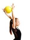 Flexible cute little girl child gymnast doing acrobatic exercise with ball isolated on a white background Royalty Free Stock Photo