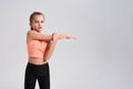 I play fitness. Flexible cute little girl child looking at camera while doing exercise isolated on a white background Royalty Free Stock Photo