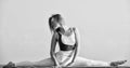 flexible girl in sportswear. Young attractive woman practicing yoga. Splits exercise. leg muscles stretching workout for