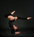 Flexible gymnast doing exercise in studio.