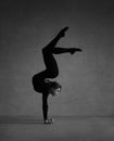 Flexible gymnast posing in black clothes