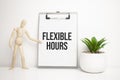 FLEXIBLE HOURS sign on small wood board rest on the easel with medical stethoscope