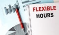 FLEXIBLE HOURS text on a notebook with pen on a chart background