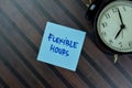 Flexible Hours write on sticky notes isolated on Wooden Table