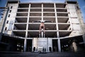 Flexible male circus Artist keep balance by hands in the concrete structure. symmetry and uniformity concept. Royalty Free Stock Photo