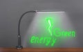 Flexible modern table LED Light shines on a drawn green electric bolt